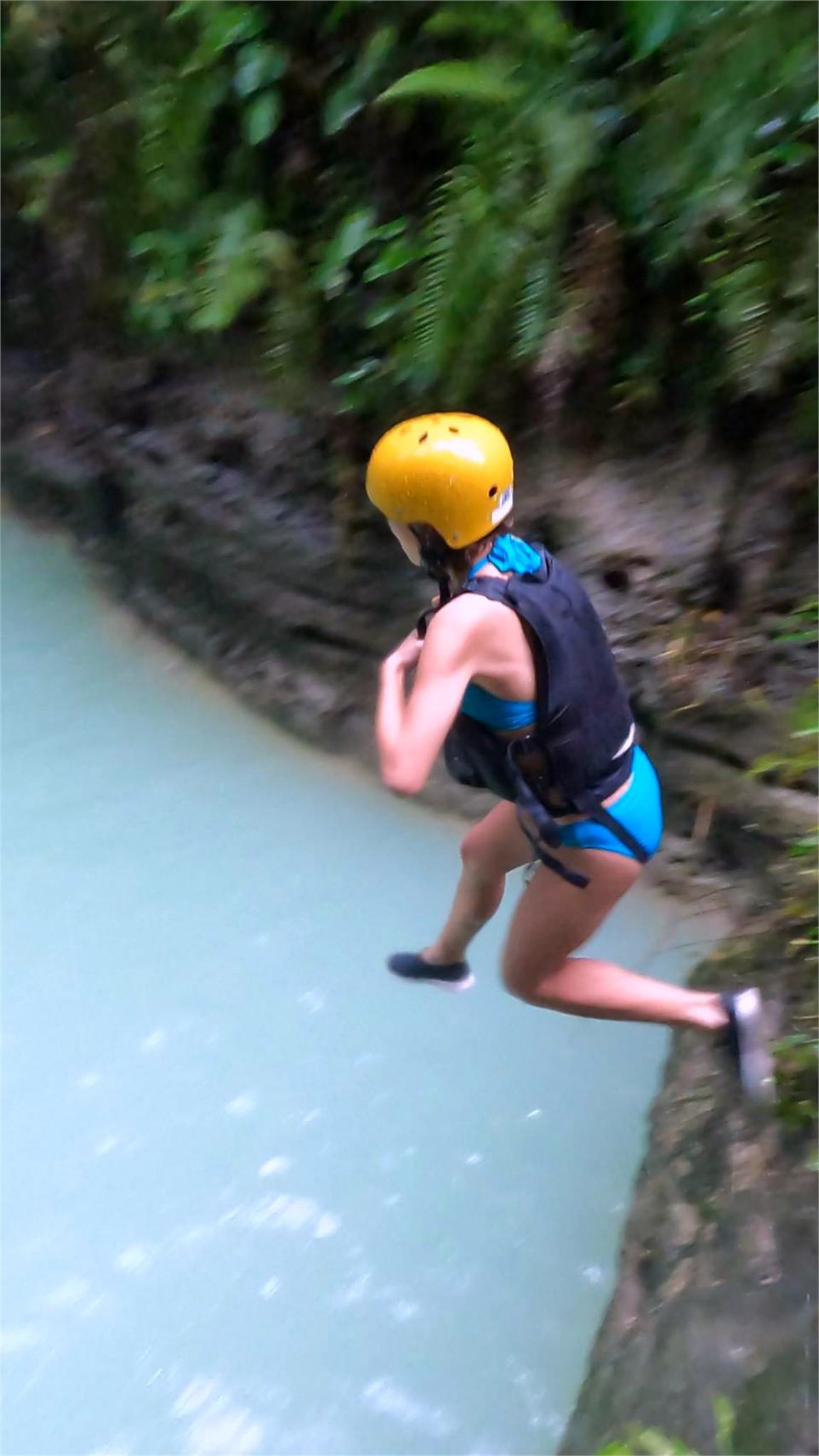 Guests cliff-jumping into turquoise pools during Kawasan Falls canyoneering, Cebu