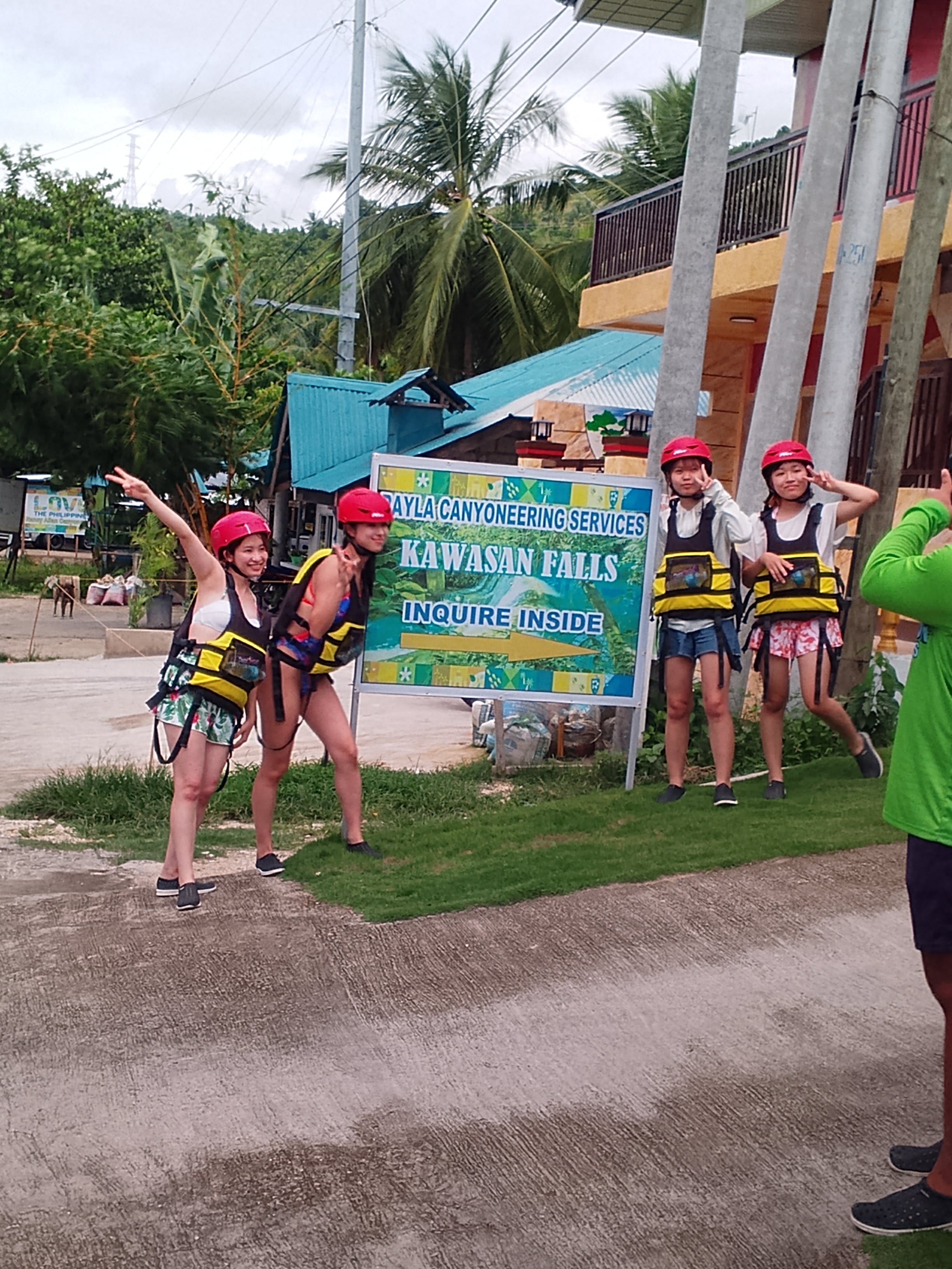Guest photo — guests geared up at Kawasan Falls canyoneering sign, Cebu