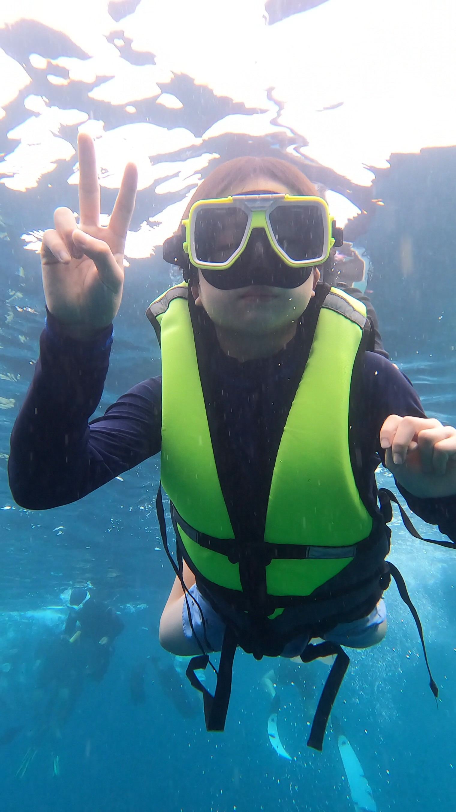 Guest photo — snorkeler giving a peace sign underwater, Cebu