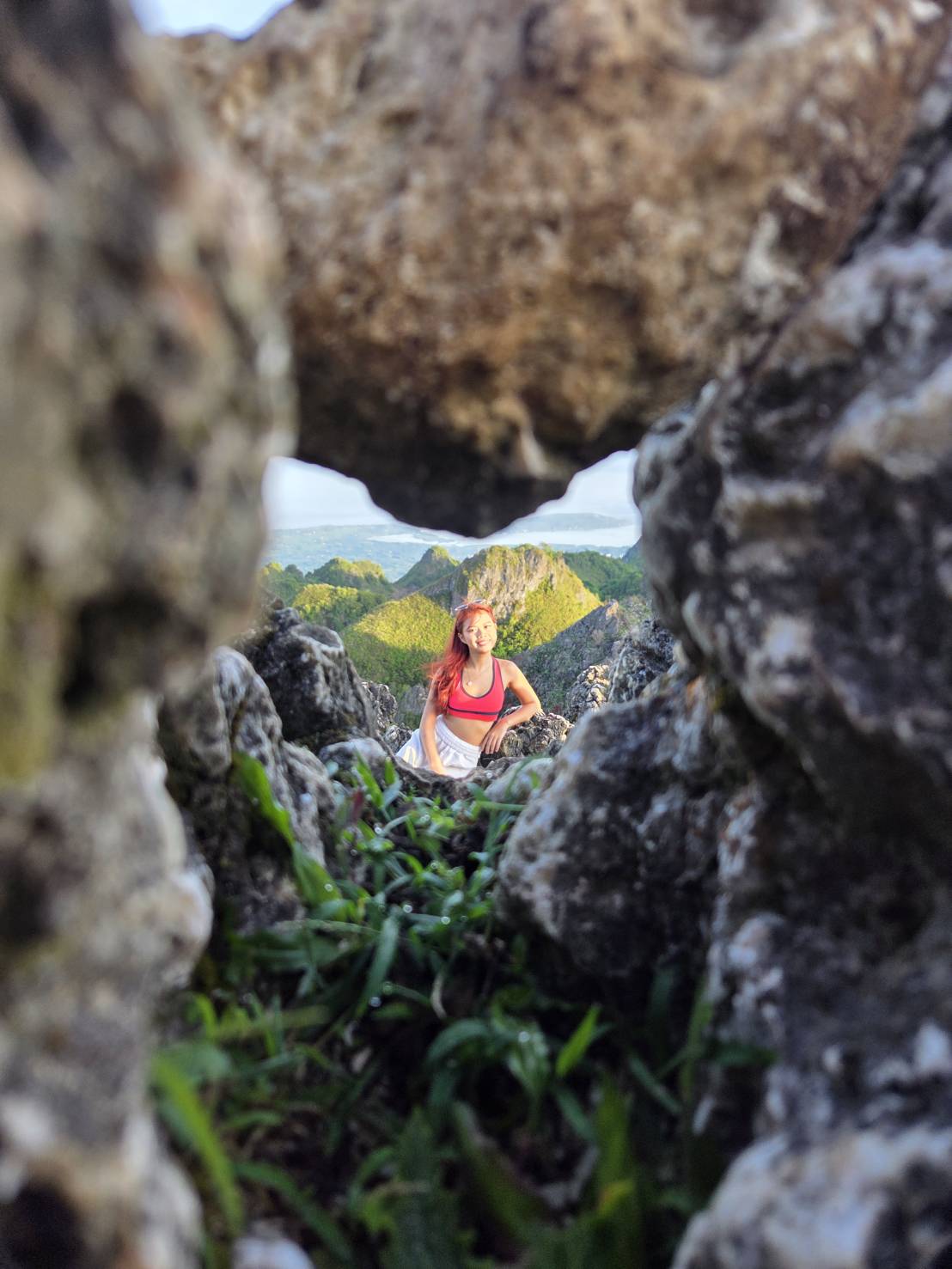 Guest photo — posed through natural rock window at Osmeña Peak, Cebu