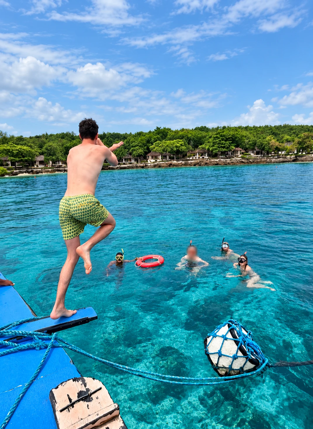 Guest jumping from a boat into clear turquoise water during a Mactan island-hopping tour